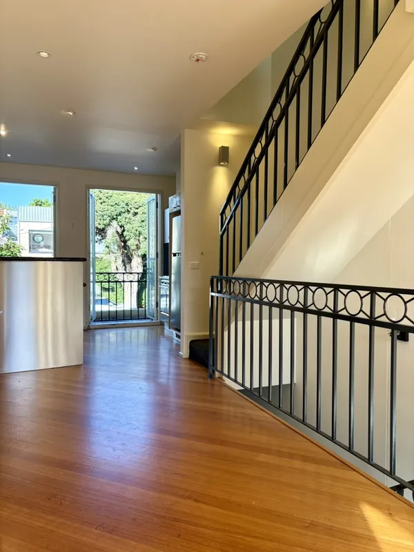 Open-plan living with timber floors and balcony, Richmond townhouse