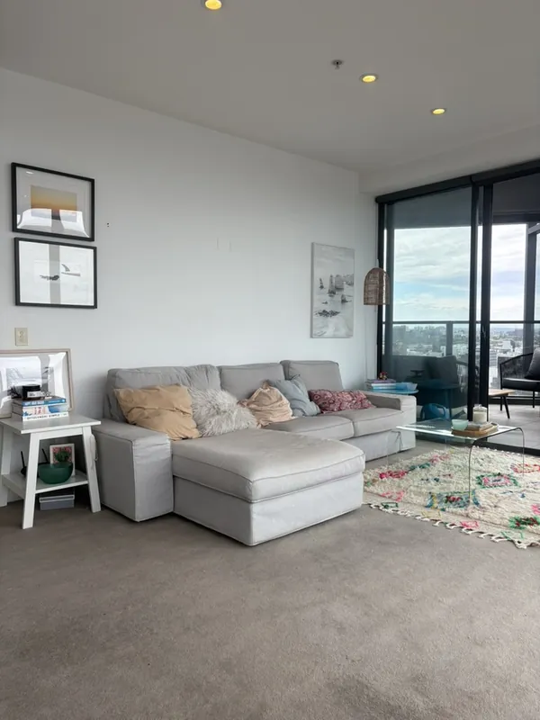 Living room with balcony and city views, South Yarra apartment