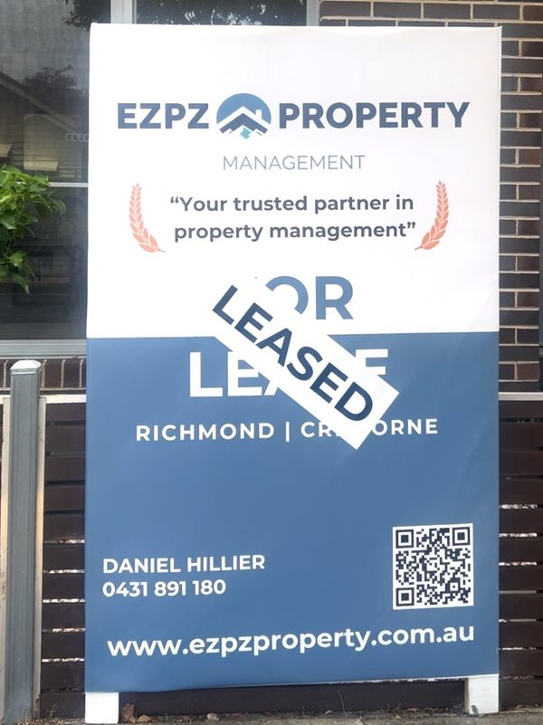 A close-up of an EZPZ Property Management 'For Lease' board with a 'LEASED' banner across it, in Richmond.